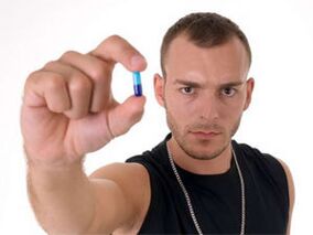 man holding a pill to increase potency